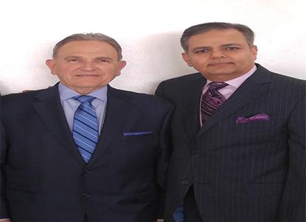 Raj Pardasani in a pinstripe suit standing with Secaucus Mayor Michael Gonnelli